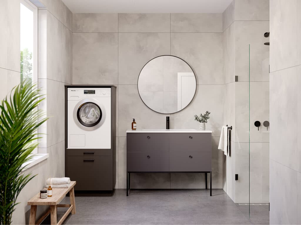 Moderne 'solo' wasmachinekast in 'metallic black' met 'ara zwart matte' handgrepen voor ingebouwde wasmachine ofx droger in strakke badkamer.